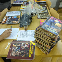 The auction table with a stack of roleplaying books